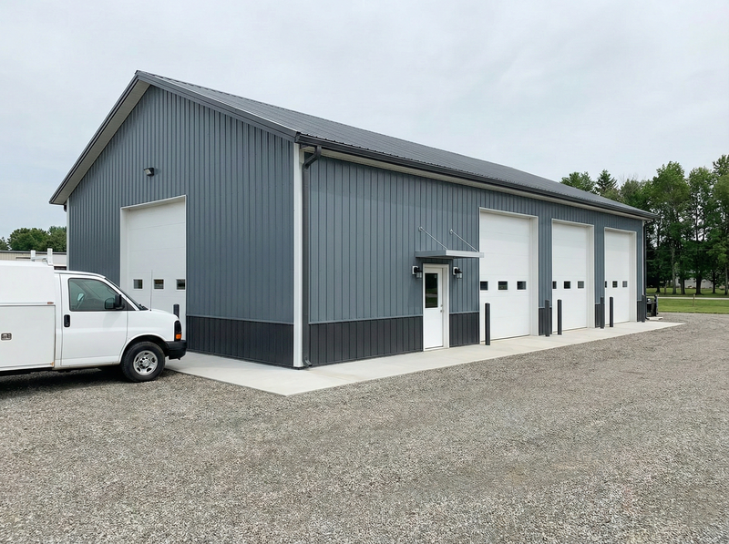 WVPFCO Indiana post frame industrial building with multiple overhead garage doors and commercial van parking access